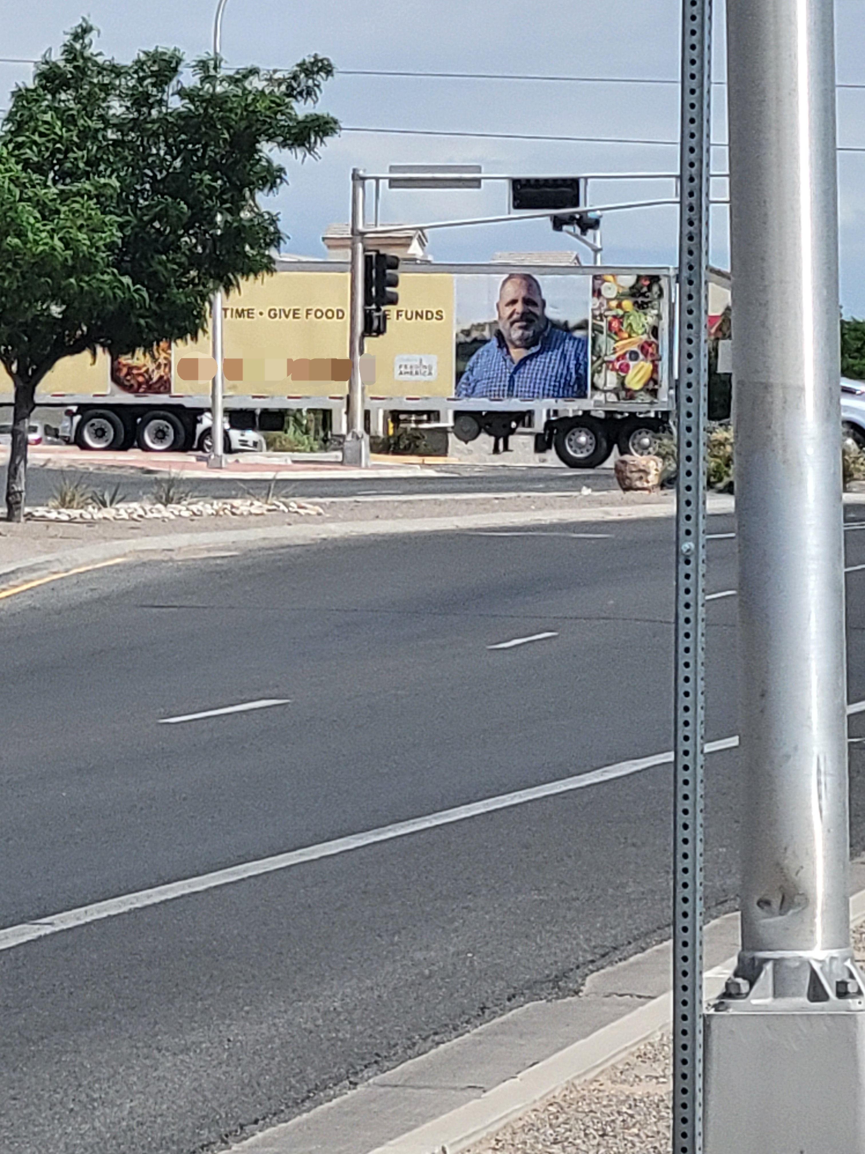 Food bank semitruck with the Feeding America logo and the quote give time, give funds, give money on it.
